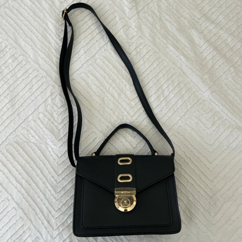 black shoulder bag with a gold buckle